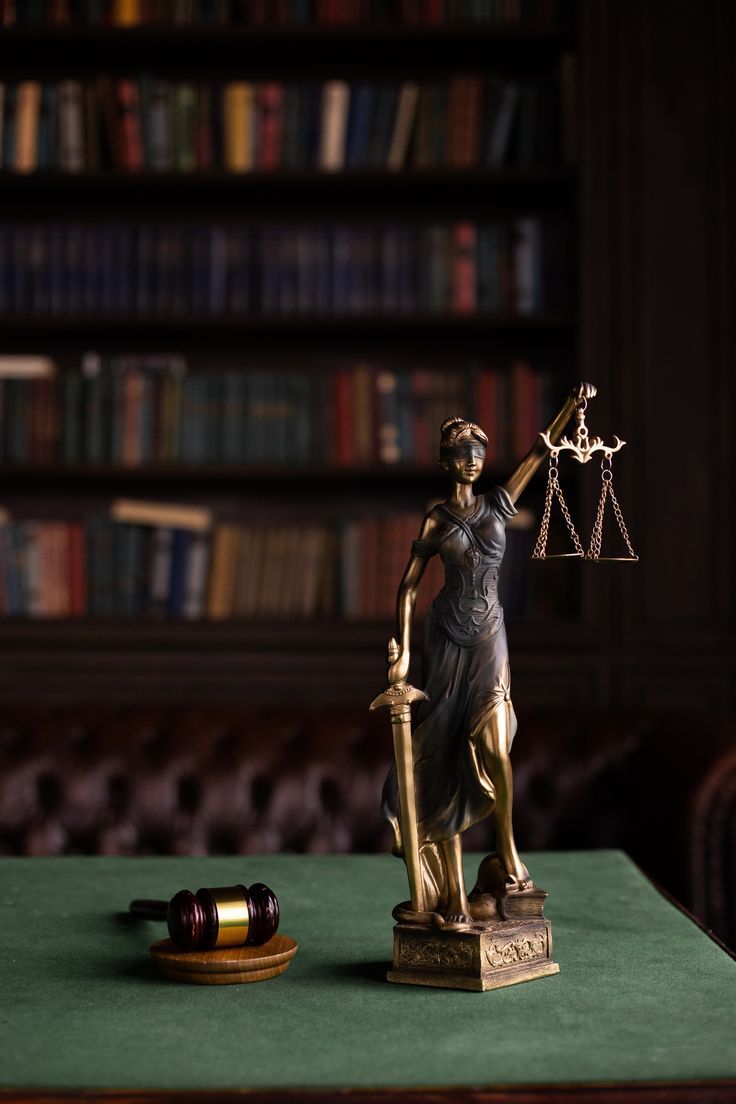 Lady Justice statue on a desk in a law library